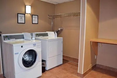 a laundry room with a washer and dryer at Holiday Inn Hinton by IHG in Hinton