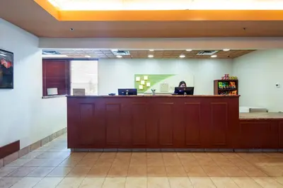 an empty waiting room with a cash counter at Holiday Inn Hinton by IHG in Hinton