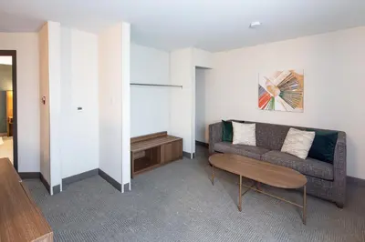 a living room with a couch and a table at Holiday Inn Hinton by IHG in Hinton