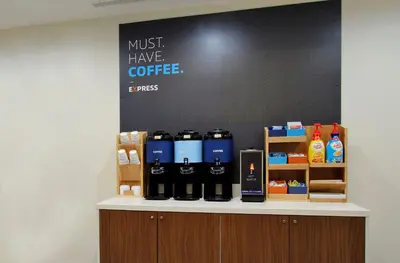 a counter with bottles of coffee on it at Holiday Inn Express Hotel & Suites-Hinton by IHG in Hinton