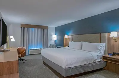 a hotel room with a bed and a television at Holiday Inn Hotel and Suites-Kamloops by IHG in Kamloops