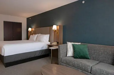 a hotel room with a bed and a couch at Holiday Inn Hotel and Suites-Kamloops by IHG in Kamloops