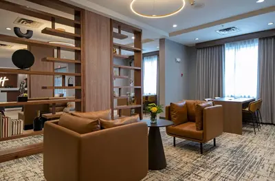 a lobby with couches and a table and chairs at Holiday Inn Hotel and Suites-Kamloops by IHG in Kamloops