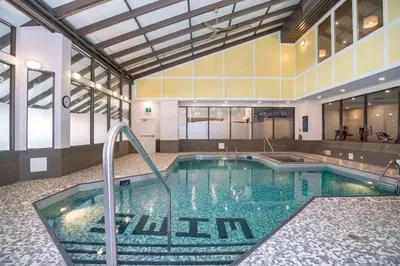 a large swimming pool in the middle of a building at Sandman Signature Calgary Downtown Hotel in Calgary