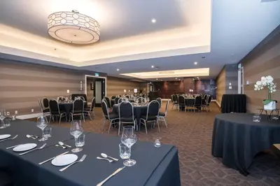 a ballroom with tables and chairs and a room filled with tables and chairsktop at Sandman Signature Calgary Downtown Hotel in Calgary