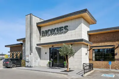 a moxes store with a sign on the front of it at Sandman Hotel Calgary Airport in Calgary