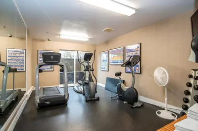 a gym with treadmills and exercise bikes in a room at Sandman Hotel Vancouver Airport in Richmond