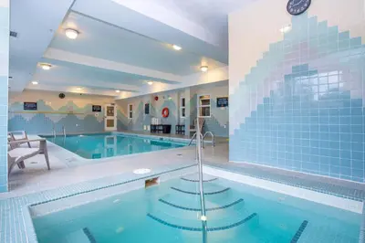 a large swimming pool with a blue tiled at Sandman Hotel Vancouver Airport in Richmond
