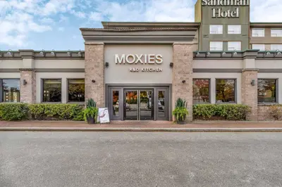 a store front with a sign that reads movies at Sandman Hotel Vancouver Airport in Richmond