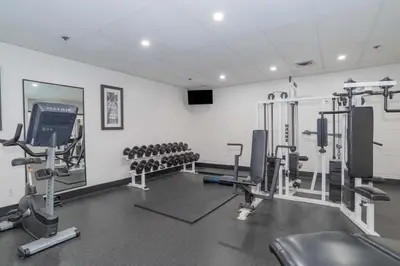 a gym with several treadmills and machines at Sandman Signature Vancouver Airport Hotel & Resort in Richmond