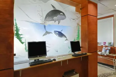 an office with two computer monitors on a desk at Days Inn by Wyndham Vancouver Airport in Richmond