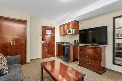a living room with a couch and a flat screen tv at Holiday Inn & Suites Lloydminster by IHG in Lloydminster