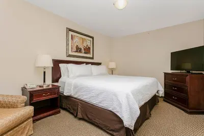 a hotel room with a bed and a flat screen tv at Holiday Inn & Suites Lloydminster by IHG in Lloydminster