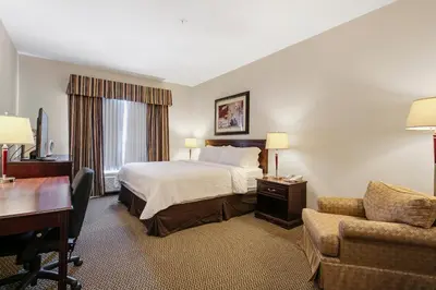 a hotel room with a bed and a desk at Holiday Inn & Suites Lloydminster by IHG in Lloydminster