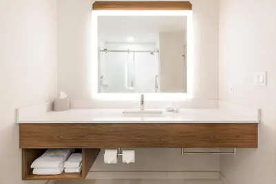 a bathroom with a sink and a mirror at Holiday Inn Express Grande Prairie by IHG in Grande Prairie