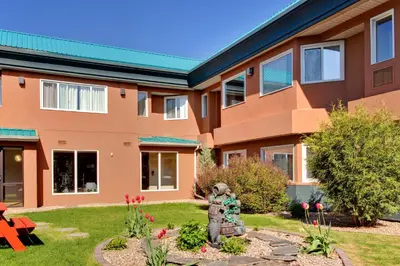 a building with a statue in the front yard at Holiday Inn Express Red Deer by IHG in Red Deer