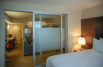a hotel room with a bed and a living room at iHOTEL & Conference Centre Red Deer in Red Deer