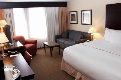 a hotel room with a bed and a couch at iHOTEL & Conference Centre Red Deer in Red Deer