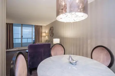 a dining room with a table and chairs at La Grande Residence at the Sutton Place Hotel in Vancouver