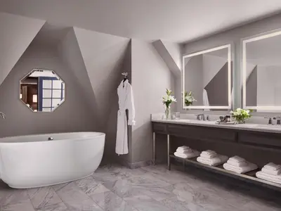 a bathroom with a tub and a sink and a mirror at Fairmont Hotel Macdonald in Edmonton