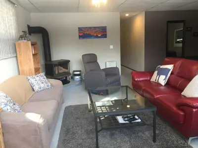a living room with two couches and a coffee table at Bed & Breakfast Monarch in Canmore