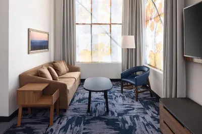 a living room with a couch and a chair at Fairfield Inn & Suites by Marriott West Kelowna in West Kelowna