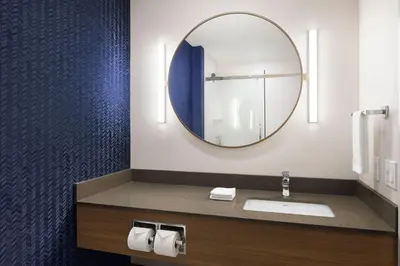 a bathroom with a sink and a mirror at Fairfield Inn & Suites by Marriott West Kelowna in West Kelowna