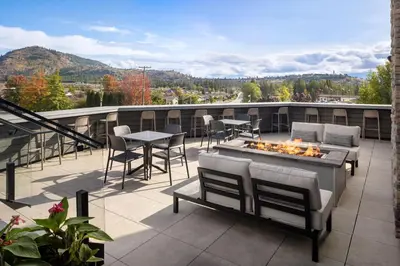 a patio with chairs and a fire pit on a roof at Fairfield Inn & Suites by Marriott West Kelowna in West Kelowna