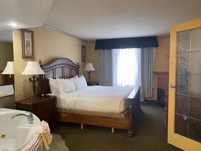 a hotel room with a bed and a window at Merit Hotel & Suites in Fort McMurray