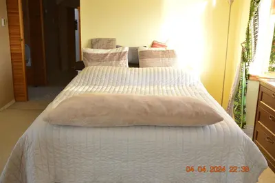 a bedroom with two beds with white blankets and pillows at Estuary House Reflexology B&B in Courtenay