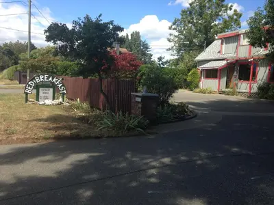 a house with a sign that reads keep eating at Estuary House Reflexology B&B in Courtenay