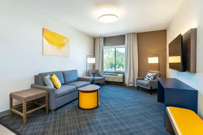 a living room with a couch and a chair at Comfort Suites Kelowna in Kelowna