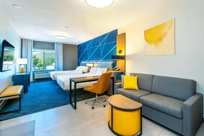 a hotel room with a bed and a couch at Comfort Suites Kelowna in Kelowna