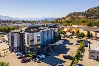 an aerial view of a town with a parking lot at Comfort Suites Kelowna in Kelowna
