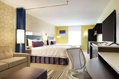 a hotel room with a bed and a desk at Home2 Suites by Hilton Fort St. John in Fort Saint John