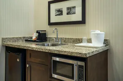a kitchen counter with a sink and a microwave at Comfort Inn & Suites in Surrey