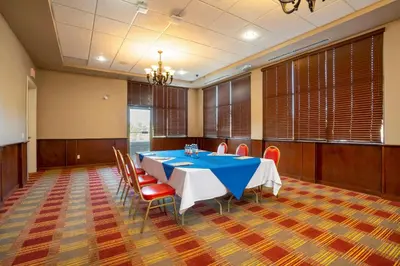 a dining room with a blue table and chairs at Comfort Inn & Suites in Surrey