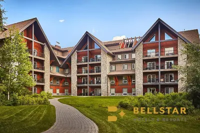 a large brick building with a pathway in front of it at Grande Rockies Resort-Bellstar Hotels & Resorts in Canmore