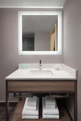 a bathroom with a sink and a mirror at Grande Rockies Resort-Bellstar Hotels & Resorts in Canmore