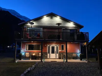 a house with a balcony on top of it at Guesthouse Austria in Stewart