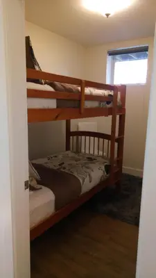 a bedroom with two bunk beds in a room at Fish Tales Cottage in Port Renfrew