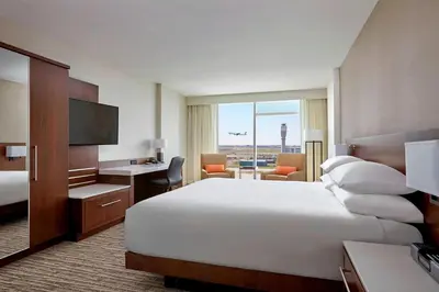 a hotel room with a large bed and a desk at Calgary Airport Marriott In-Terminal Hotel in Calgary
