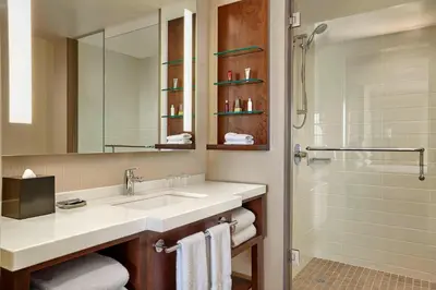 a bathroom with a sink and a shower at Calgary Airport Marriott In-Terminal Hotel in Calgary