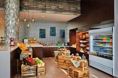 a grocery store with a counter and a grocery store with food at Calgary Airport Marriott In-Terminal Hotel in Calgary