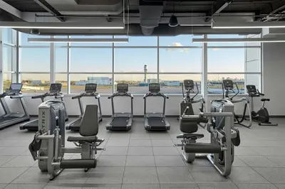 a gym with a row of exercise bikes in front of an airport at Calgary Airport Marriott In-Terminal Hotel in Calgary