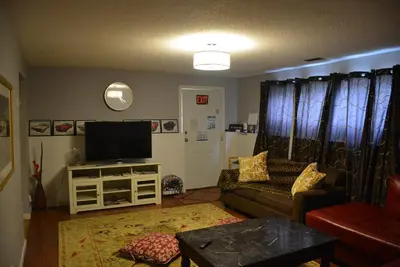 a living room with a couch and a flat screen tv at Aasra Home in Kelowna