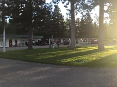 a group of trees in front of a building at Evergreen Motel in Princeton