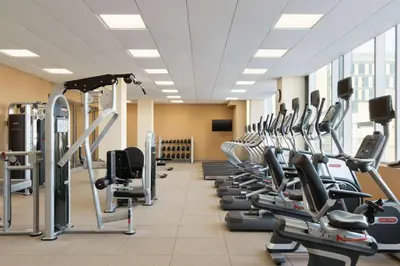 a large gym with rows of tread machines at Hilton Garden Inn Calgary Downtown in Calgary