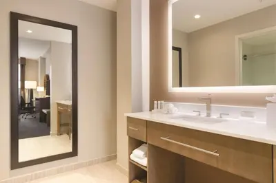 a bathroom with a sink and a mirror at Homewood Suites by Hilton Calgary Downtown in Calgary