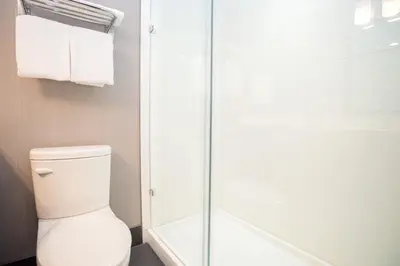 a bathroom with a toilet and a shower at Sandman Hotel Edmonton West in Edmonton